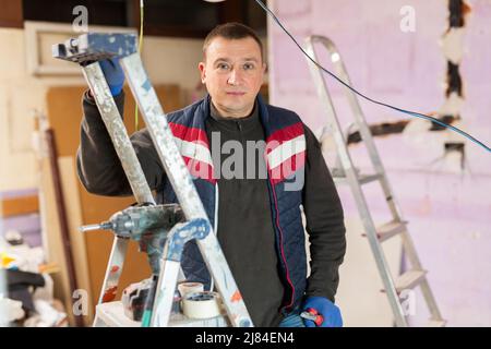 Portrait of an electrician with pliers in his hands in house under construction Stock Photo