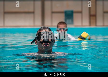 Camp Pendleton, California, USA. 29th Apr, 2022. A U.S. Marine completes the second portion of a swimming event during the 13th Annual Recon Challenge on Marine Corps Base Camp Pendleton, California, April. 29, 2022. The Recon Challenge is a 25-mile obstacle course with 10 challenges held to honor reconnaissance Marines who gave the ultimate sacrifice in combat. The course consists of live-fire ranges, swimming and close quarters tactics. Credit: U.S. Marines/ZUMA Press Wire Service/ZUMAPRESS.com/Alamy Live News Stock Photo