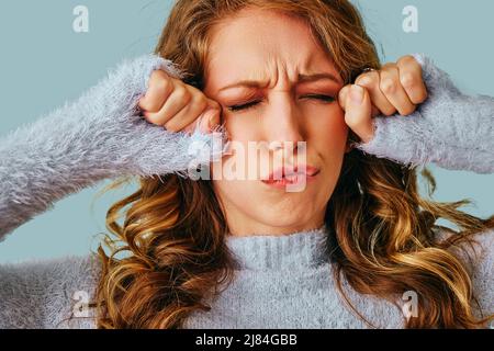 portrait of a young worried woman with a headache pain stress Stock Photo