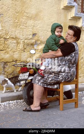 Isle of Rhodes Old Town Greece Greek,Jewish Martyrs Quarter medieval district residents grandmother child pouting making face Stock Photo