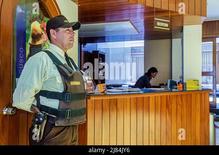 Tacna Peru,Calle Hipólito Unanue,Hotel El Meson front desk check in reception reservations lodging,Hispanic man male security guard gun,armed uniform Stock Photo