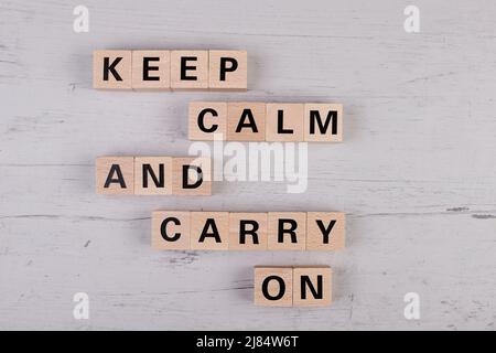 wooden blocks building the word KEEP CALM AND CARRY ON Stock Photo