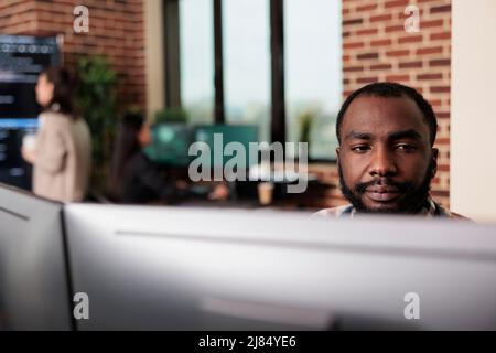 African american programmer developing high security application with multiple layers of scalability. Advanced technology cyber developer creating a node network using binary encryption. Stock Photo