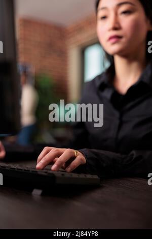 Close up of system developer writing lines of codes in order to build a anomaly analyser for database. Cyber security agency network developer doing ethical hacking to retrieve encrypted stolen data. Stock Photo