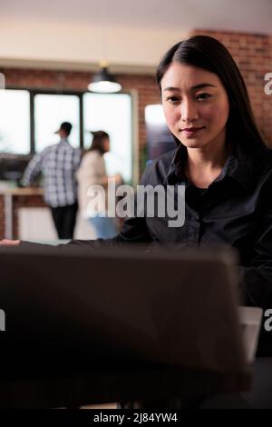 Cyber officer encrypting big chunks of data in order to secure important files. Confident cyber security officer accesing administrator rights by bypassing firewall defence system. Stock Photo