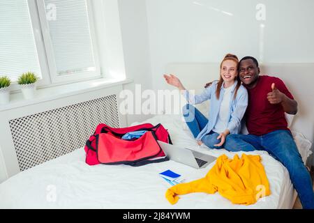 latin hispanic man and redhaired ginger woman unpacking in new house apartment Stock Photo