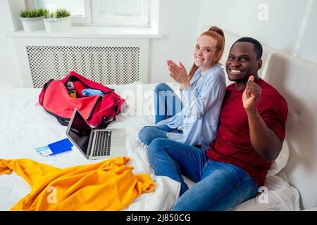 portrait of young couple with passports luggage and tickets packaging clothes Stock Photo