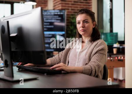 Software developer engineering an autonomous defence system using advanced artificial intelligence technology. Cyber officer encrypting big chunks of data in order to secure important files. Stock Photo