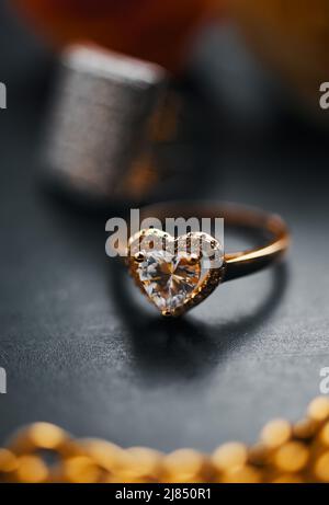 A diamond engagement ring on the black table Stock Photo