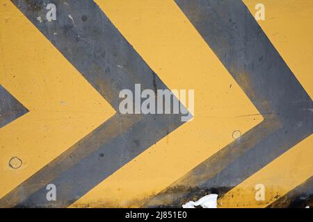 yellow and black traffic direction lines on the street Stock Photo