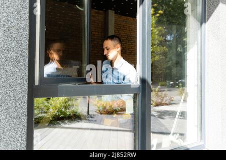 Construction worker installing window in house Stock Photo