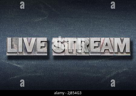 live stream phrase made from metallic letterpress on dark jeans background Stock Photo