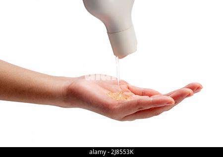 Liquid soap poured over woman's hands on white background. Beauty and hygiene concept. Stock Photo