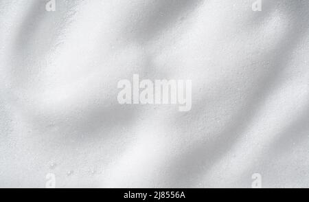 Foam bubble from soap or shampoo washing on top view.Skincare cleanser foam texture. Stock Photo