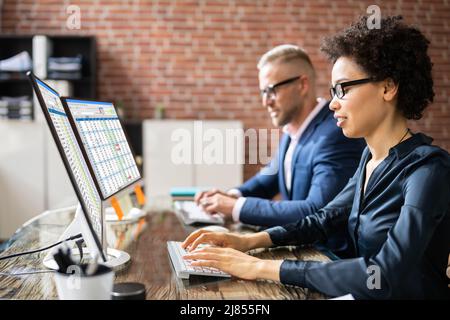 Analyst Working With Spreadsheet Business Data On Computer Stock Photo