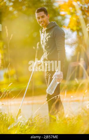 Smiling volunteer conserving environment from pollution and plastic Stock Photo