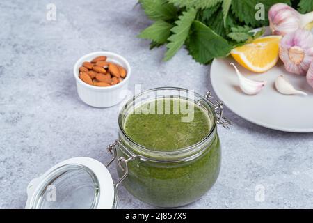 Nettle soup in jar made from young shoot. Concept of healthy food Stock Photo