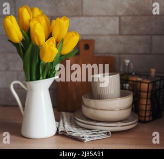 Beautiful yellow tulip flowers  on table at kitchen Stock Photo