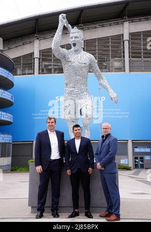 Manchester City Club legend, Sergio Aguero (centre) with Ferran Soriano (left) and sculptor Andy Scott (right) during the Sergio Aguero Statue Unveiling outside the Etihad Stadium, Manchester, to commemorate the tenth anniversary of the Club’s first Premier League title and the iconic '93:20' moment. Picture date: Friday May 13, 2022. Stock Photo