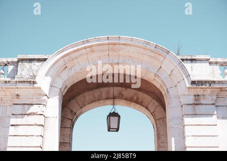 neoclassical arch with lamp on blue sky Stock Photo
