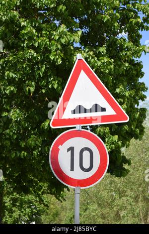speed limit 10 at road works and bad road plus many other signs Stock ...