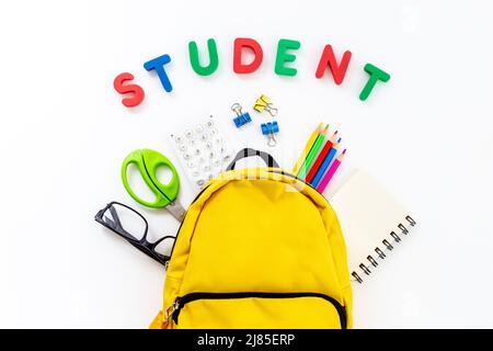 Students supplies in yellow school backpack. Back to school concept Stock Photo