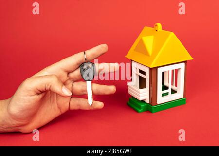 Woman's hand holding keys to new house Stock Photo - Alamy
