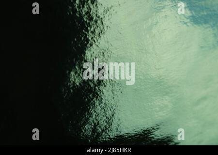 Saturated shiny green black background with light reflection. Stock Photo