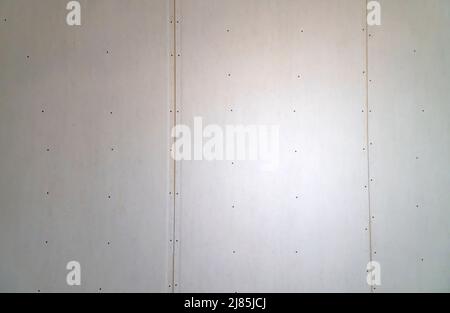 plasterboard wall with joints and screws on the construction site. Stock Photo