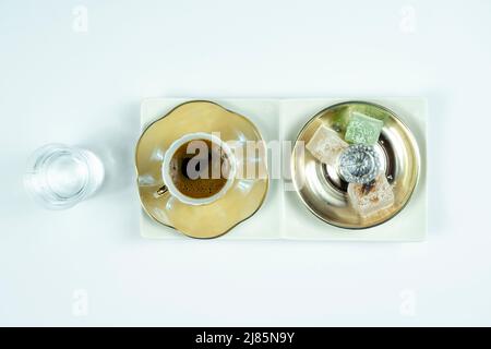 Turkish coffee serving with delight and water, isolated on white background, isolated on white background, service of Turkish coffee, serving concept Stock Photo
