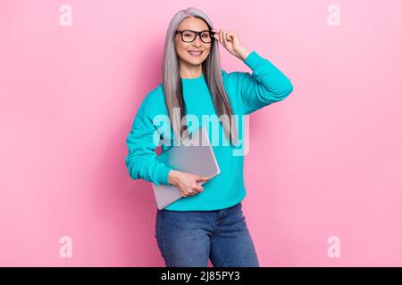 Photo of intelligent successful lady touch eyewear hold netbook isolated on pink color background Stock Photo