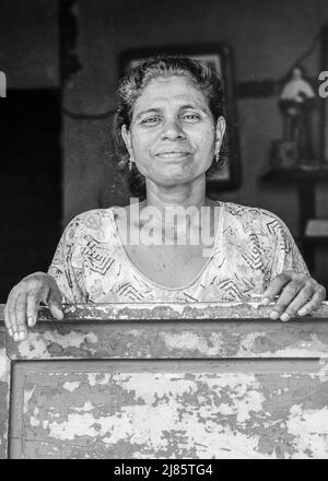 Portrait of a local woman standing in the doorway of her house in Tangassery, Thangassery, Kerala, India. Stock Photo