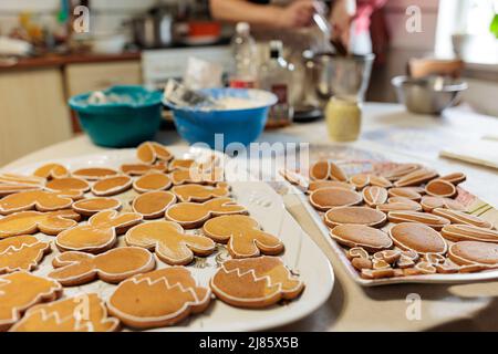 Handmade Easter gingerbread cookies in white plate on dark table.Spring symbols made from gingerbread.Homemade cookies.Easter bunny,rabbit,eggs and du Stock Photo