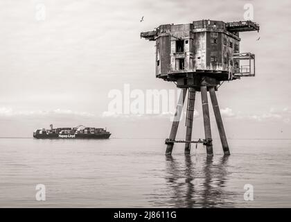 Maunsell Fort and container ship in the Thames Estuary Stock Photo