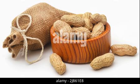 Fresh Peanuts in sack and bowl over white background Stock Photo