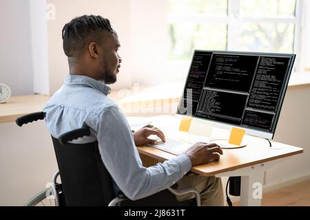 African American Coder Using Computer At Desk. Web Developer Stock Photo