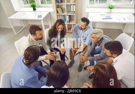 Group of business people having serious discussion during work meeting in office Stock Photo