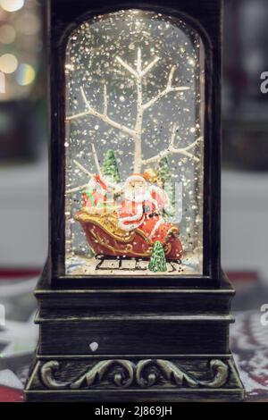 Retro flashlight with a figure of santa on sleigh. Christmas decoration. Stock Photo