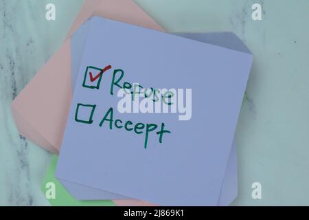 Concept of Refuse or Accept write on sticky notes isolated on Wooden Table. Stock Photo