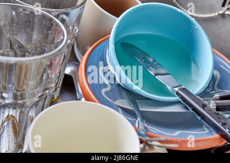 Dirty dishes, glasses, cutlery in kitchen sink Stock Photo