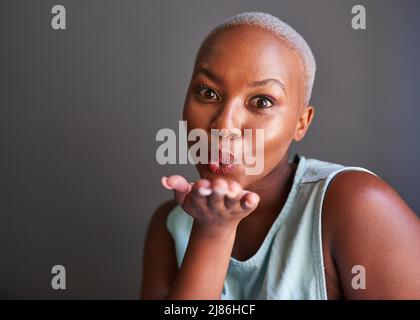 A young Black model blows kisses to the camera Stock Photo