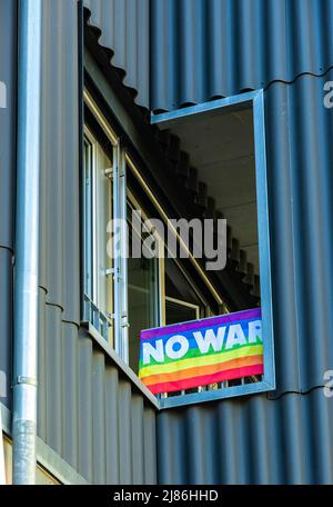 Biel, Switzerland - Mai 11, 2022: Pacifist flag in rainbow colors with peace inscription No war Stock Photo