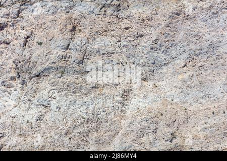 Grey rock shaped by the sea, salt and wind background texture. Stone formation, rough mineral material. Abstract natural rocky surface. Greek island G Stock Photo