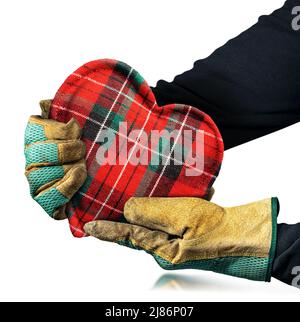 Manual worker with protective work gloves holding a fabric heart shape, isolated on white background. Stock Photo