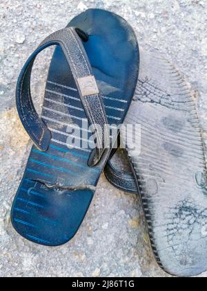 Broken FlipFlops shoes on the floor in Tulum Quintana Roo Mexico. Stock Photo