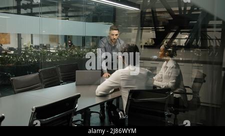 Indian arab male boss leader man coach corporate presentation for diverse businesspeople in office businessman presents new business plan project Stock Photo