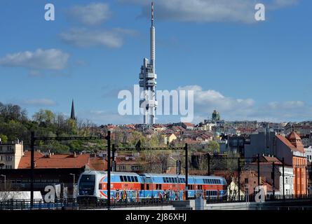 Prague, Czech Republic. 13th May, 2022. The city train CityElefant of Czech Railways passes through the overpass on the background Zizkov Television Tower during sunny day in Prague in the Czech Republic. (Credit Image: © Slavek Ruta/ZUMA Press Wire) Stock Photo