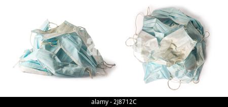 pile of used dirty surgical protective face mask, blue disposable hygienic medical face mask, infectious waste concept, isolated on white background Stock Photo