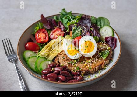 Medium boiled eggs with sasld, healthy breakfast Stock Photo