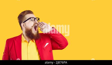 Serious stylish chubby bearded man makes loud advertisement announcing important information. Stock Photo